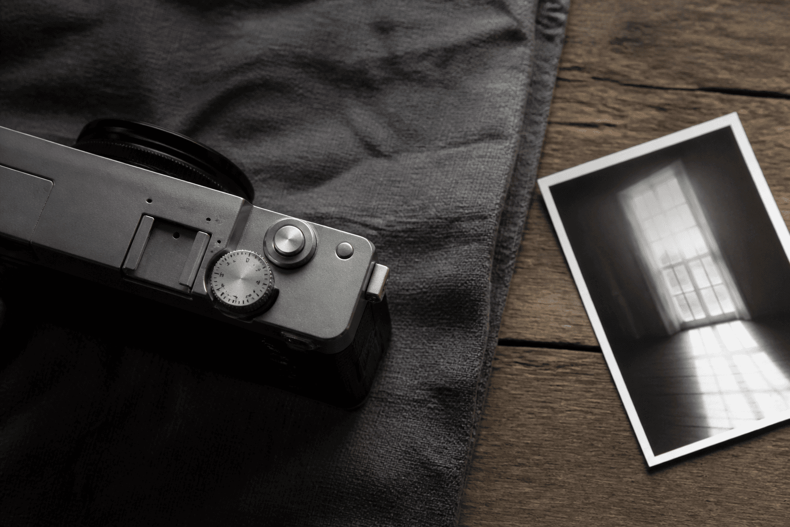 Close view of an unbranded camera exposure dial beside a bright-window print