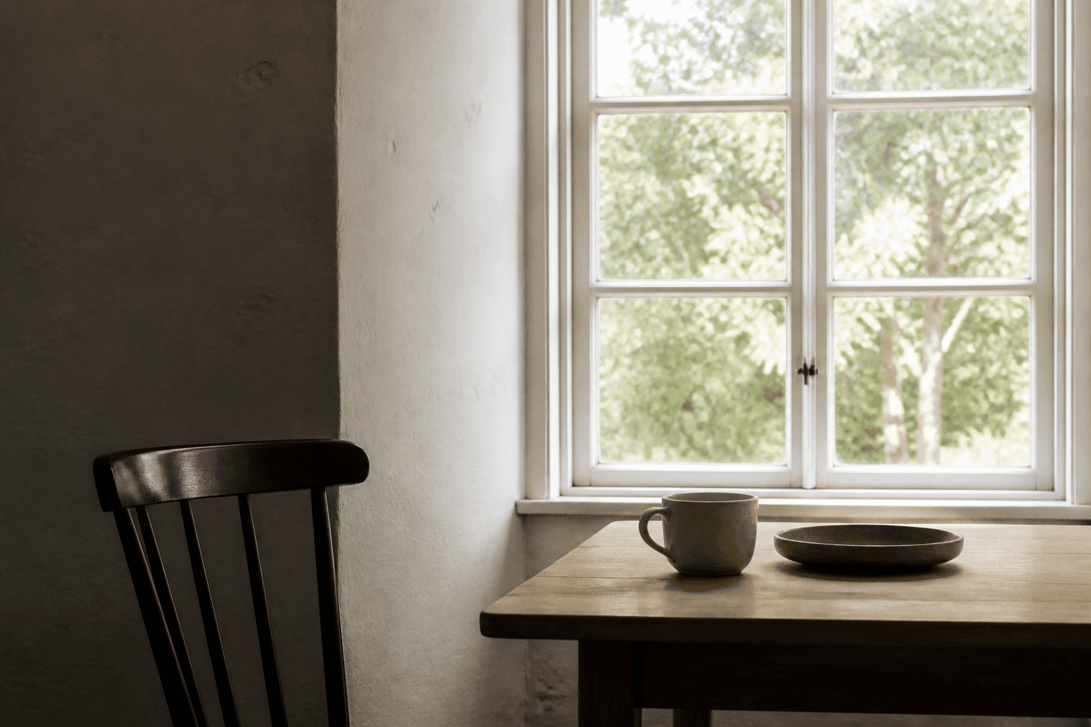 Bright window, cup and chair in a softly exposed quiet interior